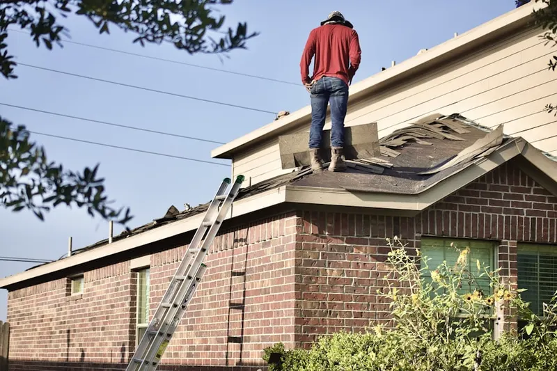 Professional roofer working on a residential roof in Petal